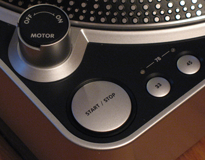 A close up on the T.90's speed and start/stop controls, along with the platter dots designed to reflect the turntable's built in lights to give you a rough sense of the platter's speed and direction.